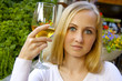 Beautiful lady in the restaurant with a glass of wine.