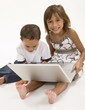 Photo: Two young kids playing on a laptop Two young kids playing on a laptop