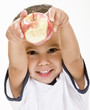 Photo: A young boy holds a fresh red apple A young boy holds a fresh red apple