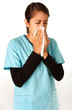 Female Nurse Sneezing into Tissue