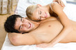 Young attractive happy amorous couple in bedroom