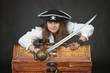 Woman pirate with a sabre and treasures