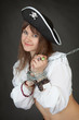Young sexy girl in a costume pirate chained in a chain
