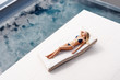 Top view of a young woman sunbathing on a recliner by the pool