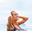Cute woman in the pool, outdoors