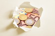 euro money behind hole in paper