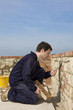 Man bricklaying wall with trowel