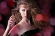 beautiful blond woman applying perfume on her body beautiful blond woman applying perfume on her body