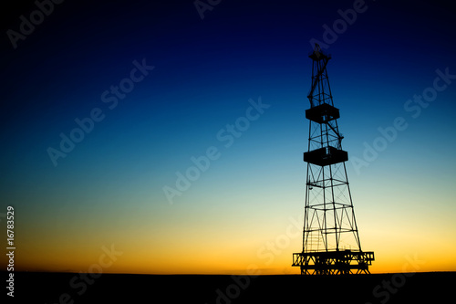 Photo: Oil rig silhouette over blue sky Oil rig silhouette over blue sky