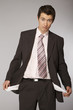 Young caucasian businessman showing his empty pockets