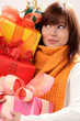 Portrait of young surprised woman holding gifts
