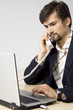 Portrait of young business man communicating on telephone