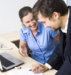 Business couple working with papers and laptop