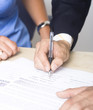 A business man  sign the agreement