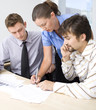 Business people looking at papers in meeting room