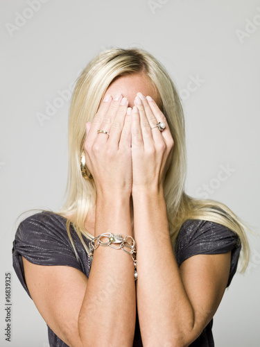 Photo: Portrait of a woman hiding in her hands Portrait of a woman hiding in her hands