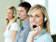 Three businesspeople working with headsets Three businesspeople working with headsets