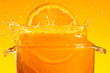 Orange slice falling into the liquid