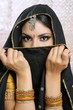 Beautiful brunette asian girl with black veil on face
