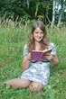 student reading book in park.