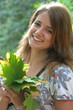 Young pretty woman with the autumn leaf