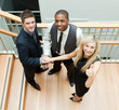 Foto: Businesspeople with hands together and looking at the camera Businesspeople with hands together and looking at the camera