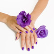 Purple manicure and violet flowers Purple manicure and violet flowers