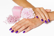 Woman hands with manicure, candle, flower and beads Woman hands with manicure, candle, flower and beads