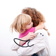 female doctor hugs small patient
