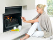 Pretty woman by a fireplace at home