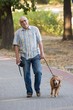 Smiling old senior with his dog.