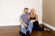 Photo: Attractive young couple sitting in their new home Attractive young couple sitting in their new home
