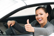 Frau im Auto macht Topdaumen
