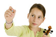 young girl holding a pen and a violin isolated on white