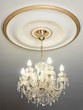 Big electric chandelier hanging down from a ceiling