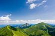 Mountain-ridge and blue sky with white clouds