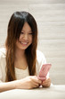 Girl playing her mobile phone Girl playing her mobile phone