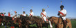 Polo team on horseback in field