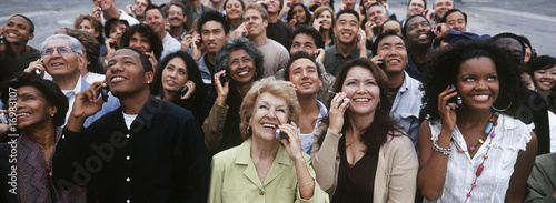 Photo: Crowd of people using mobile phones, outdoors Crowd of people using mobile phones, outdoors