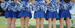 Five cheerleaders in row, back view, mid section