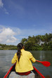 Woman in canoe paddling