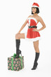 Mrs Claus standing with one foot on gift