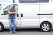 Photo: Man standing next to van Man standing next to van