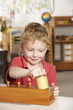 Photo: Young Boy Playing at Montessori/Pre-School Young Boy Playing at Montessori/Pre-School