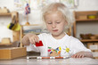 Adult Helping Young Children at Montessori/Pre-School