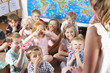 Montessori/Pre-School Class Listening to Teacher on Carpet