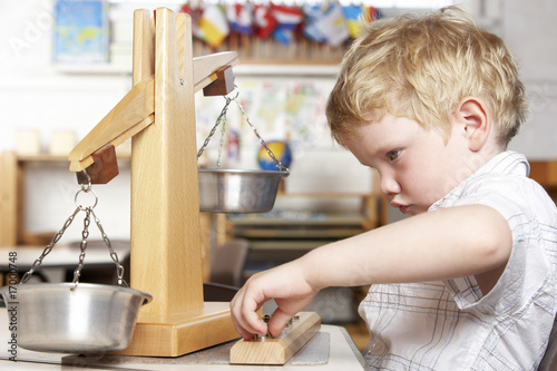 Photo: Young Boy Playing at Montessori/Pre-School Young Boy Playing at Montessori/Pre-School