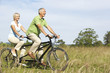 Photo: Mature couple riding tandem Mature couple riding tandem