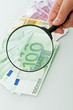 Banknotes and magnifying glass