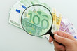 Banknotes and magnifying glass